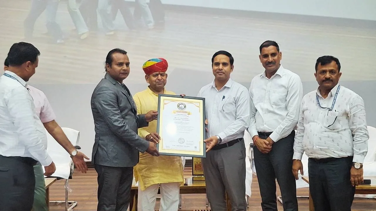Founder and Director Yogguru Rakesh Bhardwaj presenting a Yoga Book of Records certificate to Prof. Govind Sahay Shukla, Vice Chancellor of Dr. S.R. Rajasthan Ayurved University, Jodhpur, for a Mass Yoga World Record